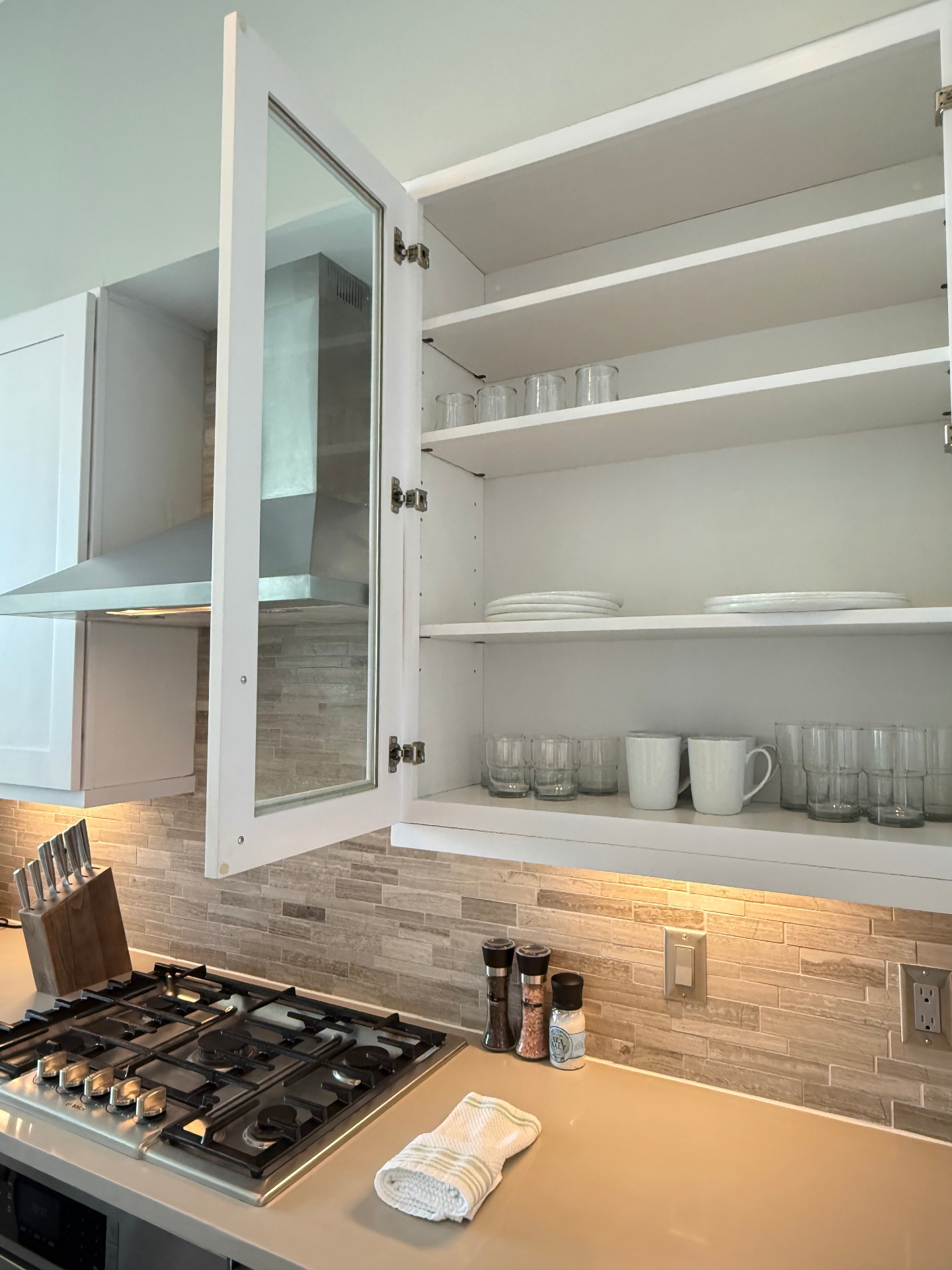 Organized, spotless kitchen cabinets after cleaning