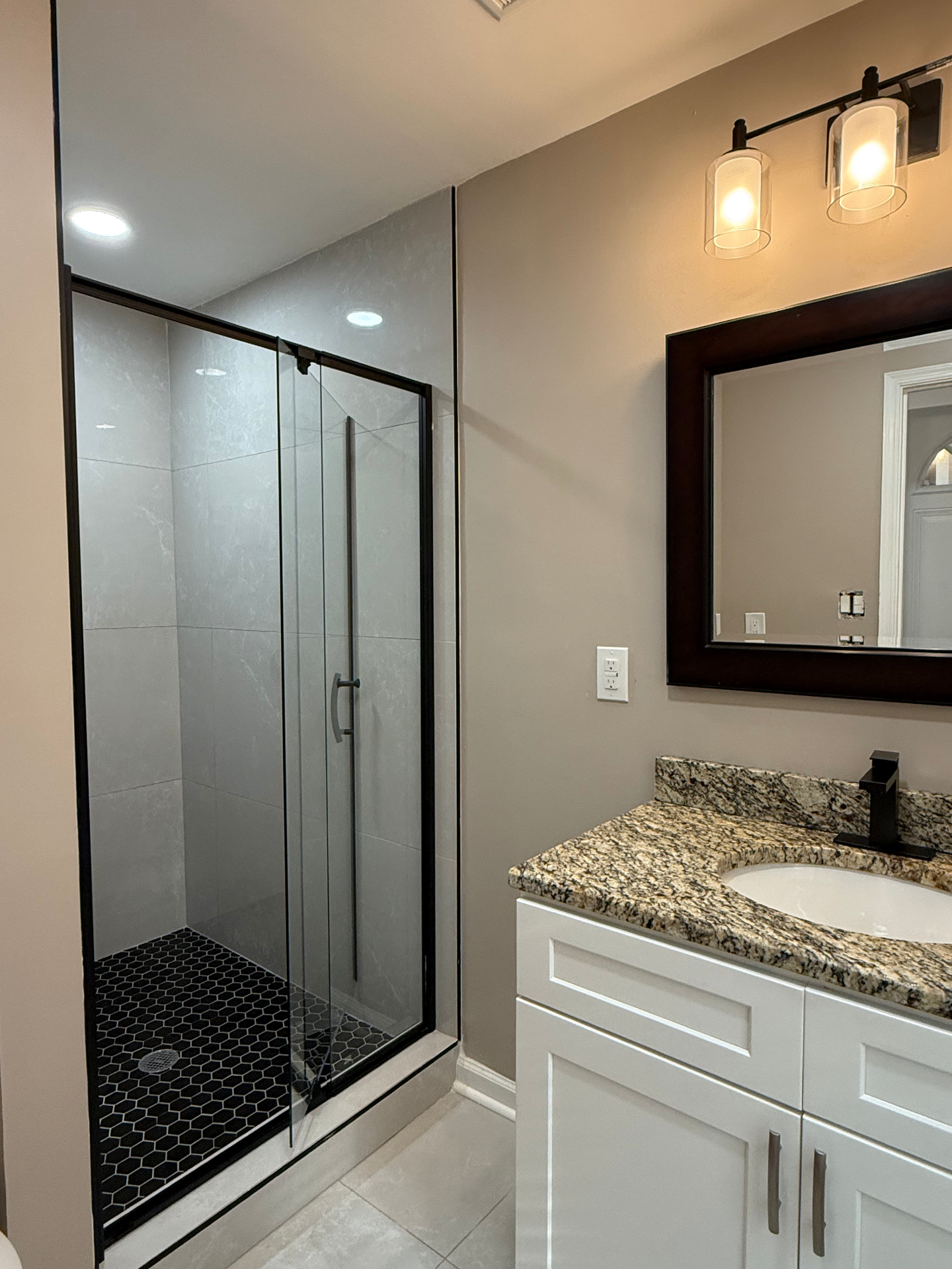 Sparkling bathroom with glass shower after cleaning